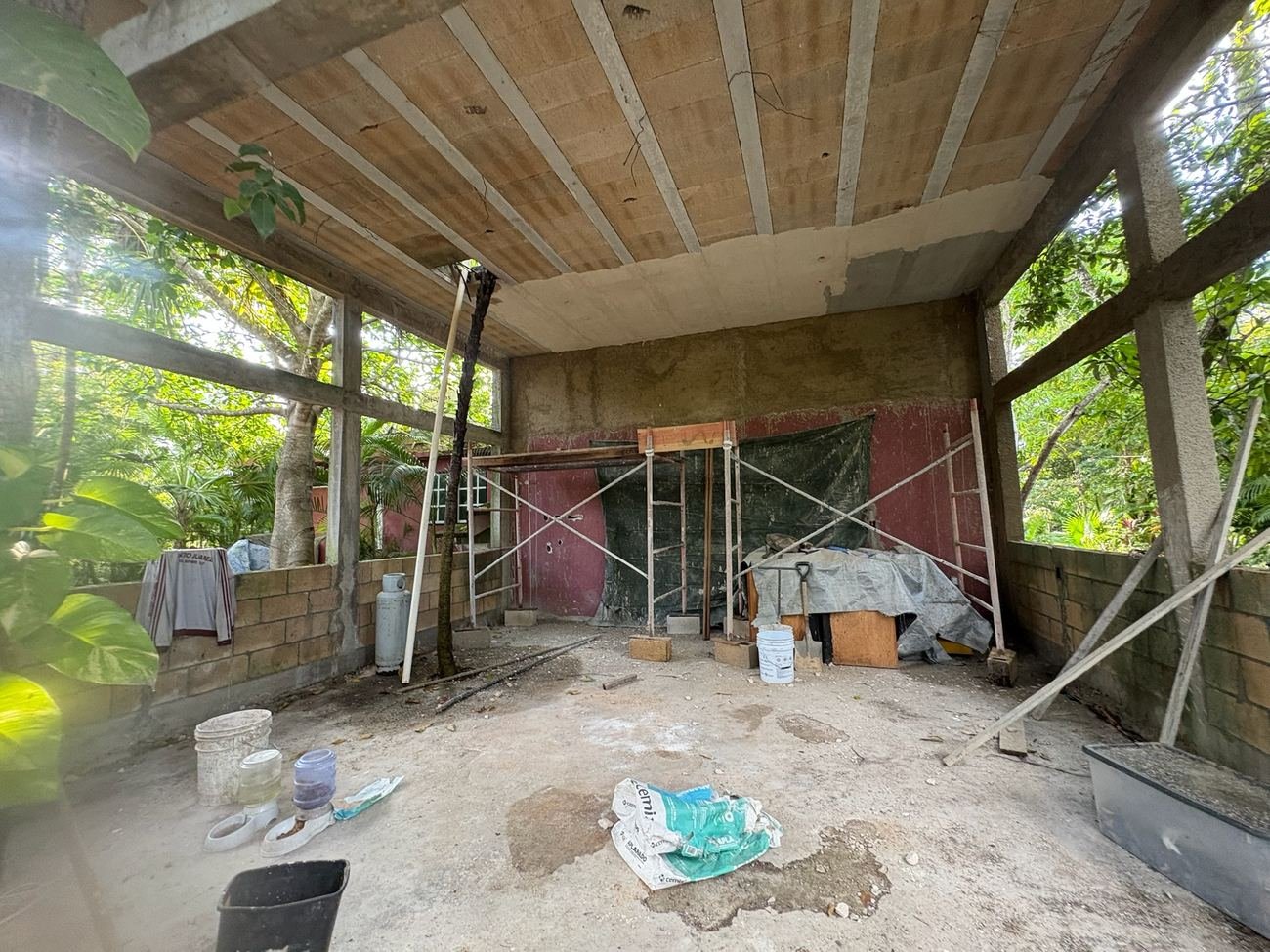 Interior wall under construction with scaffolding at Rancho Verde Tulum, before