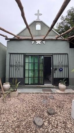 Small chapel-style building with green facade at Rancho Verde Tulum