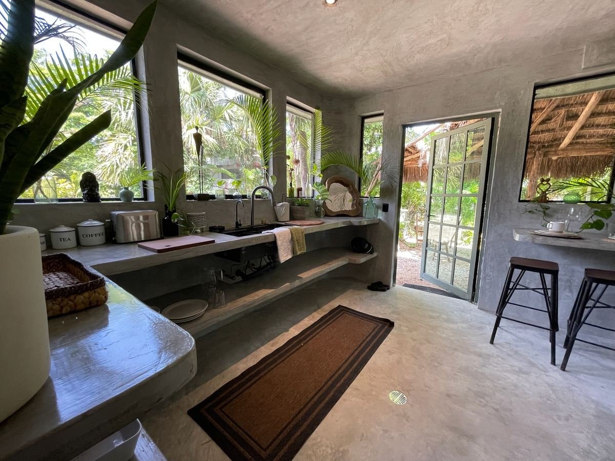 Finished kitchen with jungle view at Rancho Verde Tulum