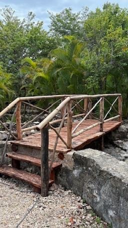 Wooden garden bridge pathway at Rancho Verde Tulum