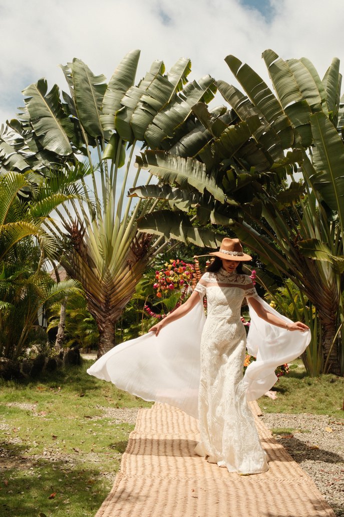 Bride walking a palm-lined path at Rancho Verde Tulum