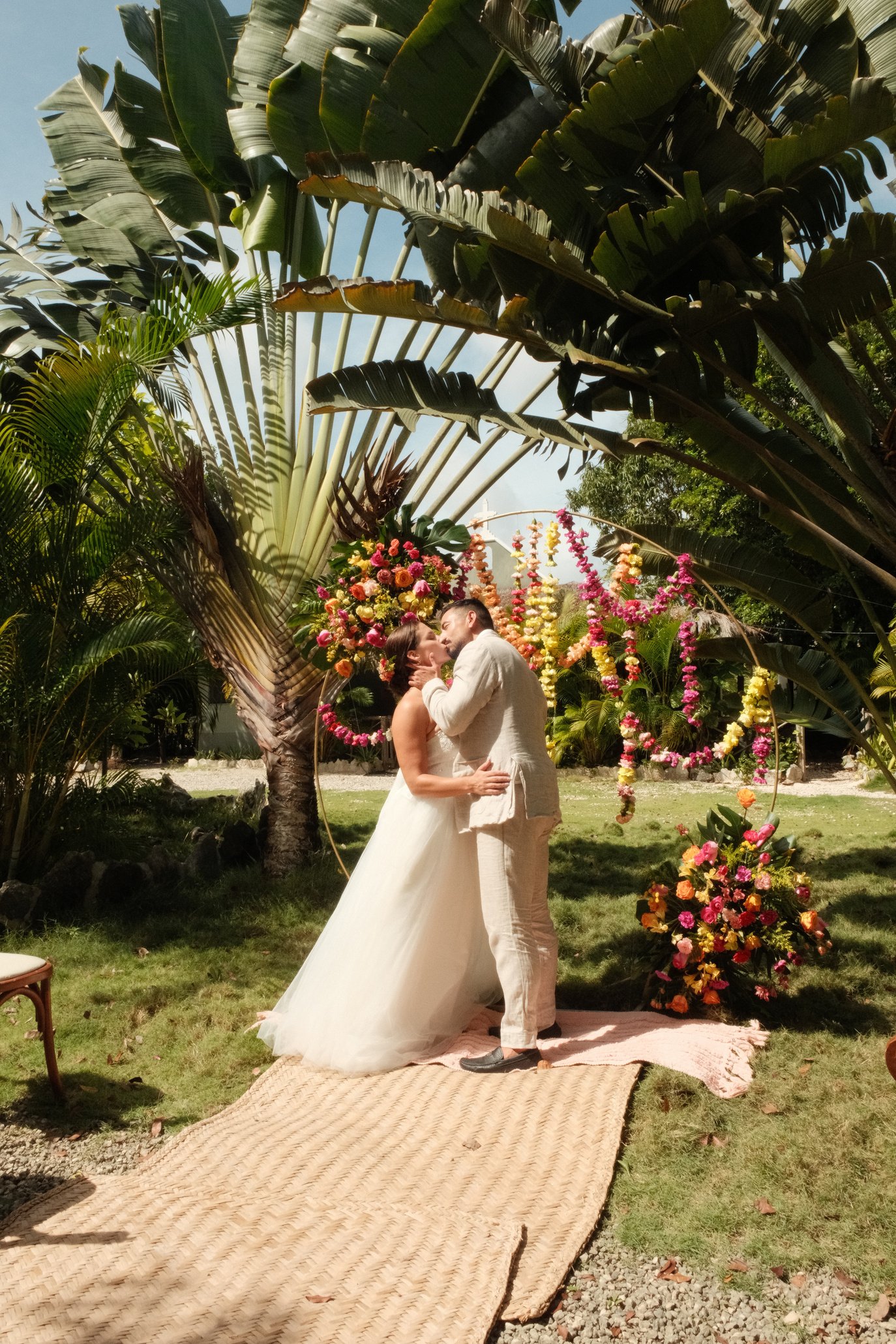 Wedding ceremony arch with tropical floral arrangement at Rancho Verde