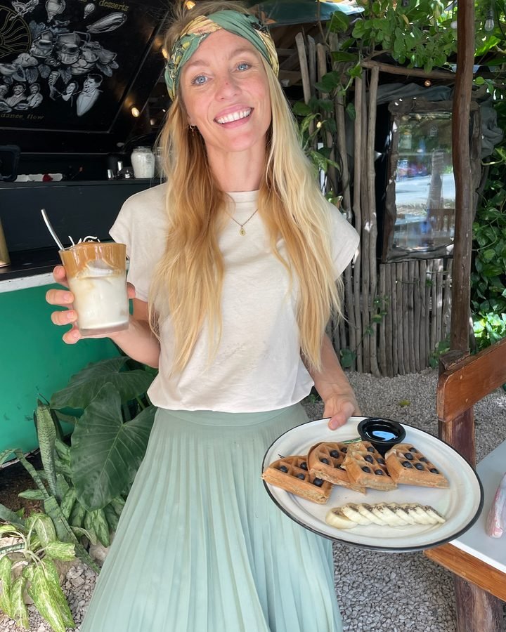 Server holding a slice of cake at Liefs Tulum