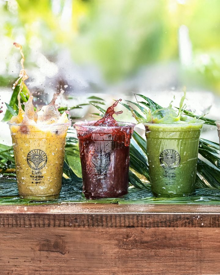Row of colourful smoothies on wood at Liefs Tulum