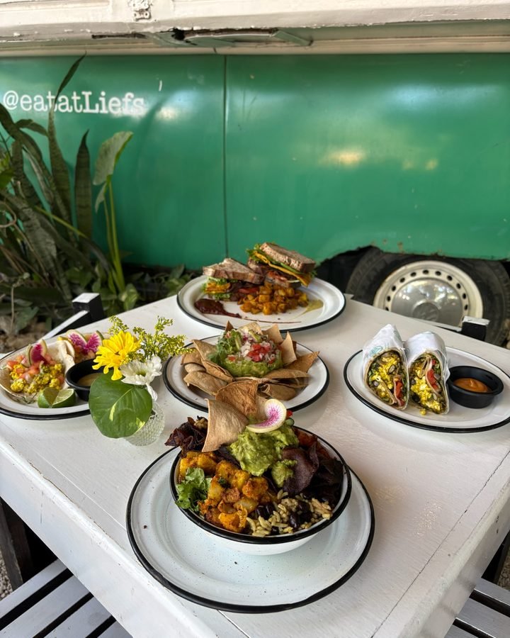 Vegan plates served inside a green VW van at Liefs Tulum