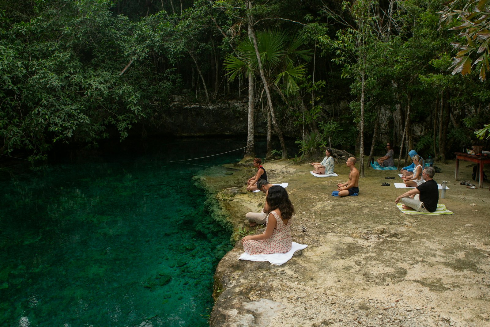 Guided group meditation at a hidden cenote near Rancho Verde Tulum
