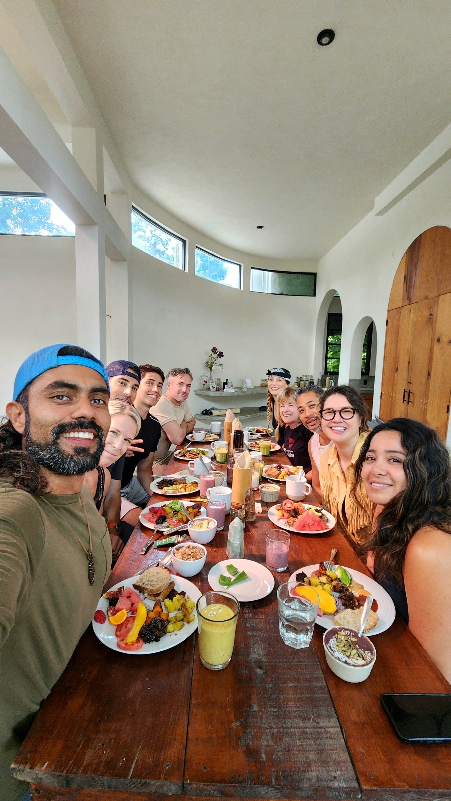 Retreat guests sharing a community dinner at Rancho Verde Tulum