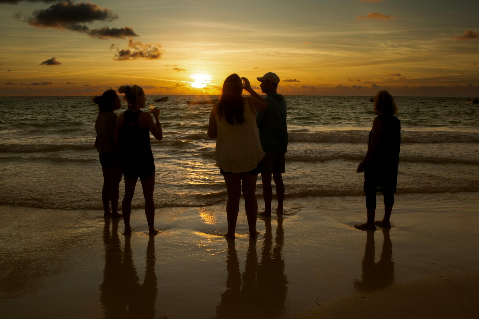 Retreat guests watching the sunset together on the beach in Tulum