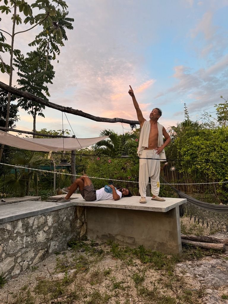 Two guests on a rooftop at sunset at Rancho Verde Tulum