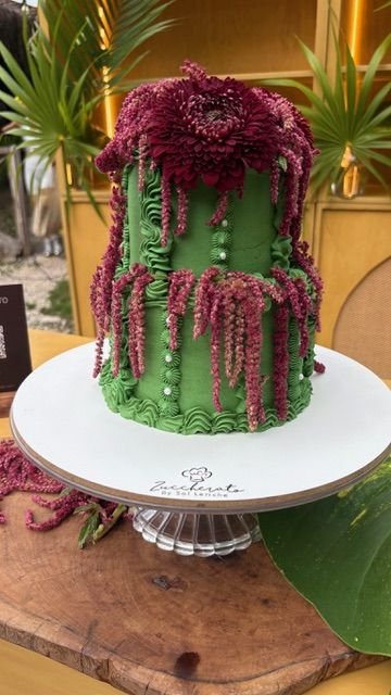 Green and burgundy wedding cake at Rancho Verde Tulum