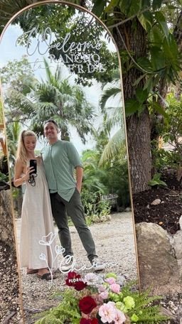Couple at a long table under woven lanterns at Rancho Verde Tulum